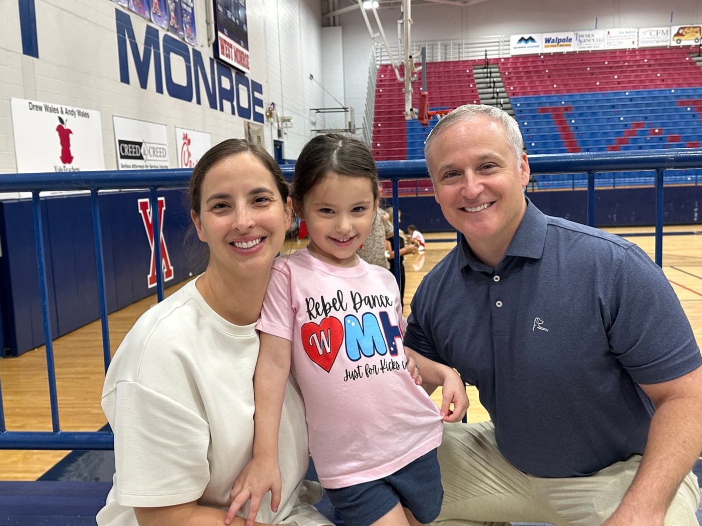 Adam and Lindsey Cossey with Emilia at a dance event in Monroe