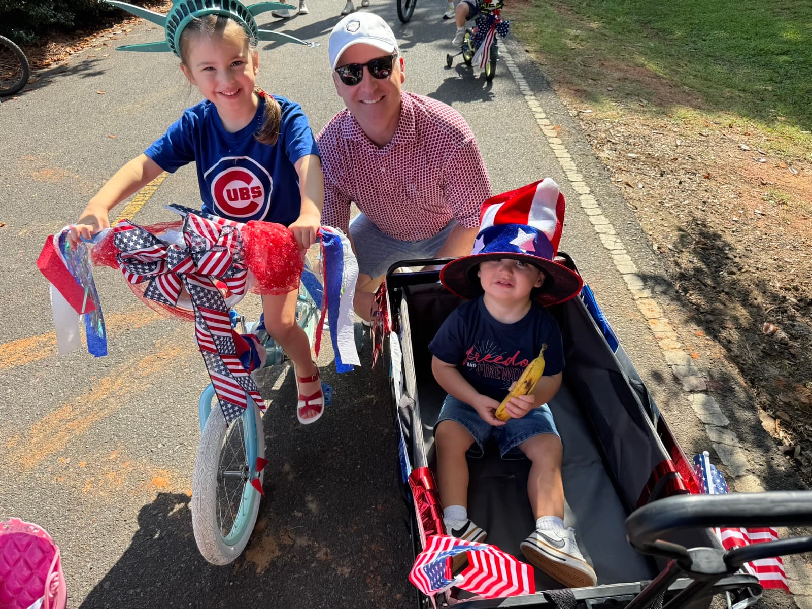 Adam Cossey with his children at a Fourth of July bike parade